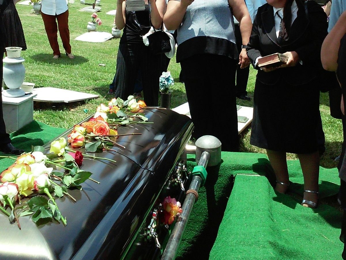 group of people attending burial