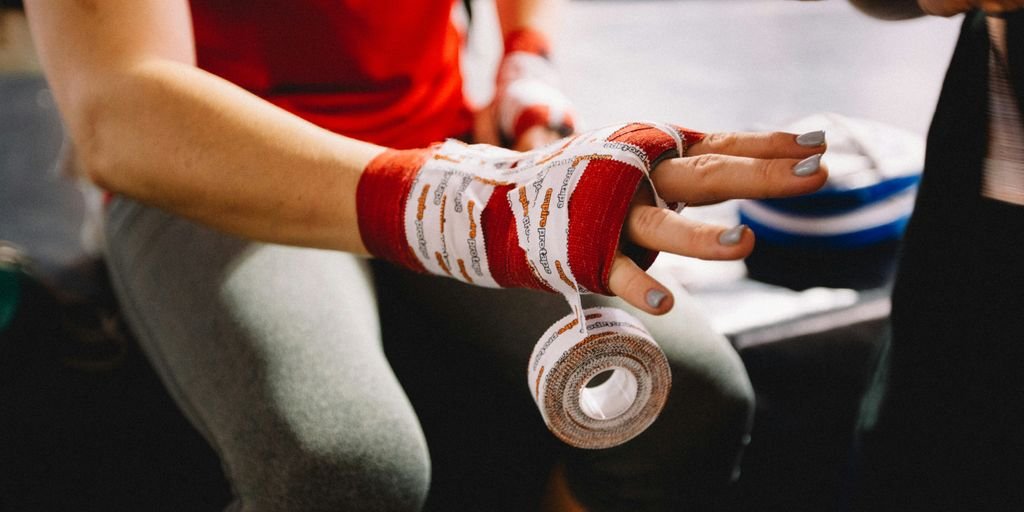 person wrapping bandage